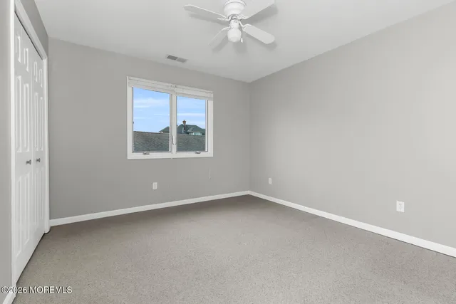 a bathroom with a granite countertop sink toilet and mirror
