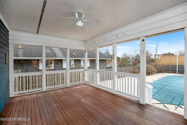 a view of a porch with wooden floor and iron stairs