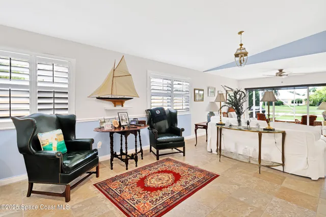 a living room with furniture a rug and a window
