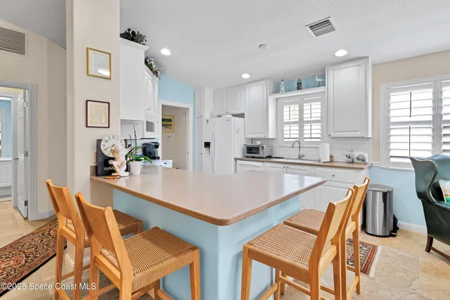 a view of a dining room with furniture and window