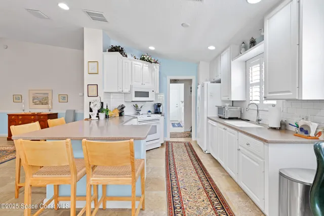 a kitchen with cabinets and refrigerator