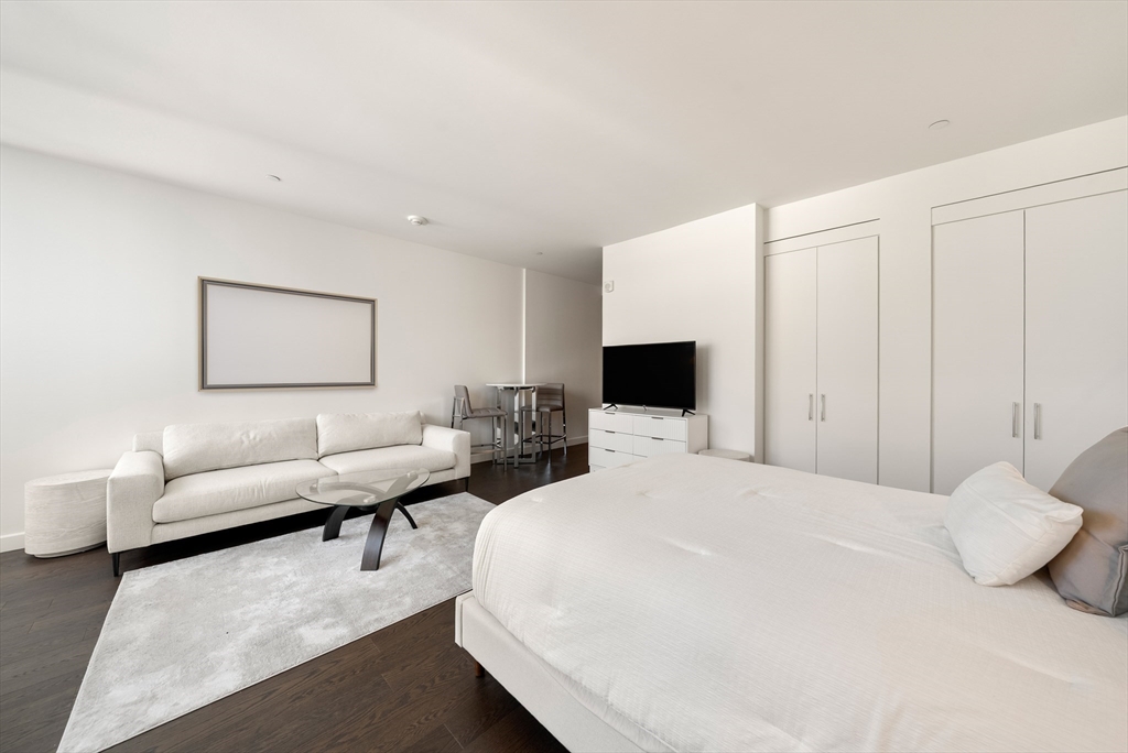 40 Trinity Place, Unit 1518 Boston, MA 02116 - Photo 6 of 25 a bedroom with a bed and a couch