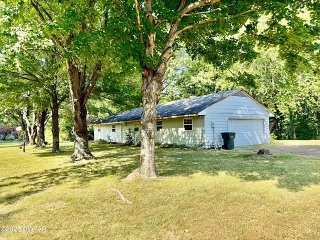 a house that has a tree in front of it