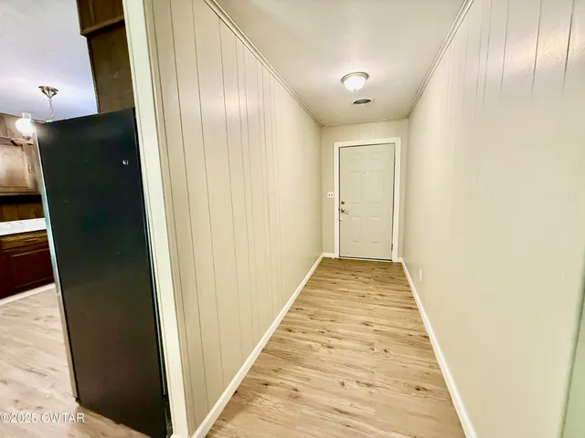 a view of gallery with wooden floor