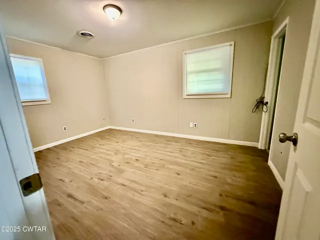 a view of a room with wooden floor and small staircase
