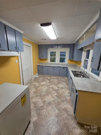 a living room with a stove and a refrigerator