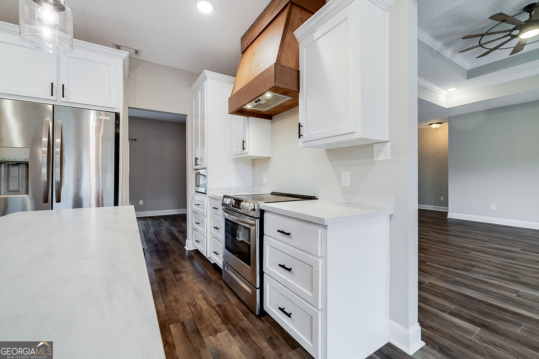 127 Winding Way Road Pembroke, GA 31321 - Photo 14 of 38 a kitchen with stainless steel appliances a stove a sink and a refrigerator