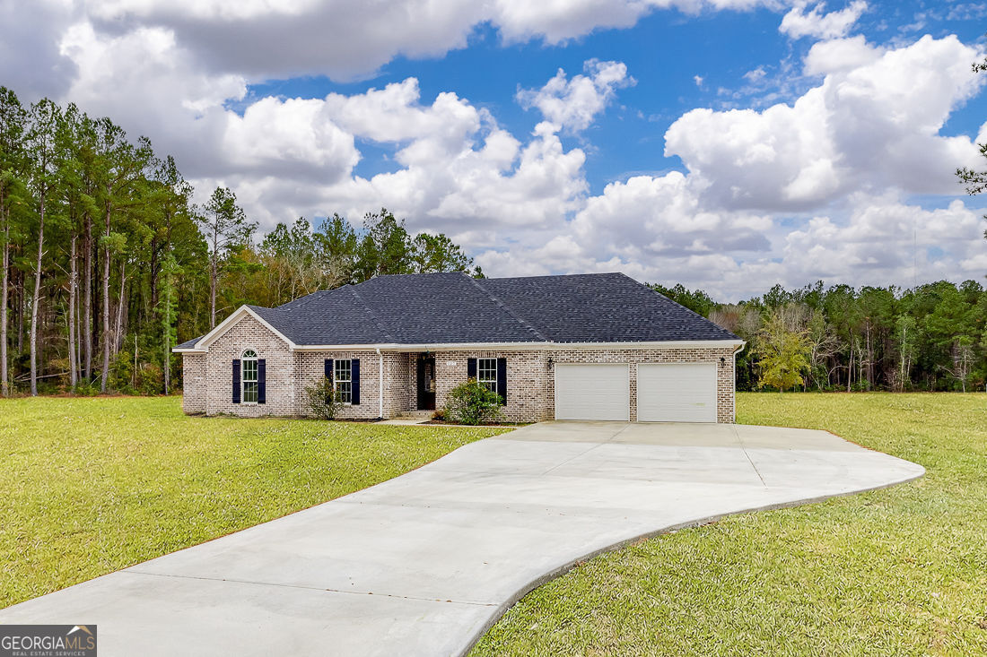 127 Winding Way Road Pembroke, GA 31321 - Photo 2 of 38 a house with yard in front of it