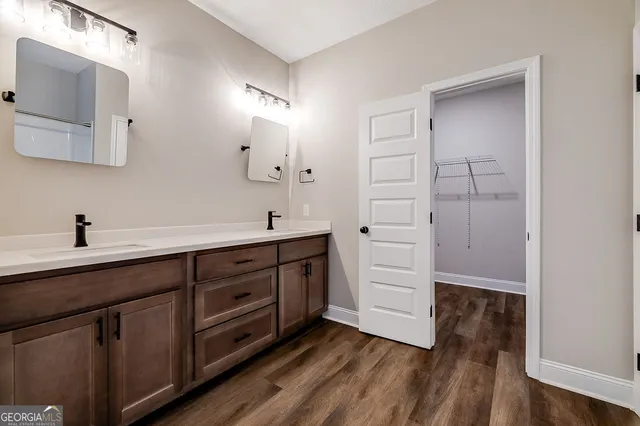 a spacious bathroom with double vanity and mirrors