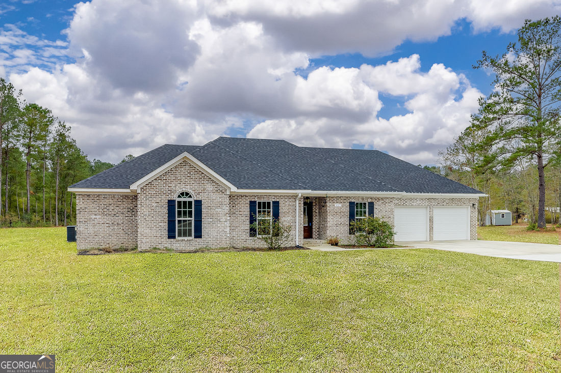 127 Winding Way Road Pembroke, GA 31321 - Photo 3 of 38 a front view of house with yard and green space