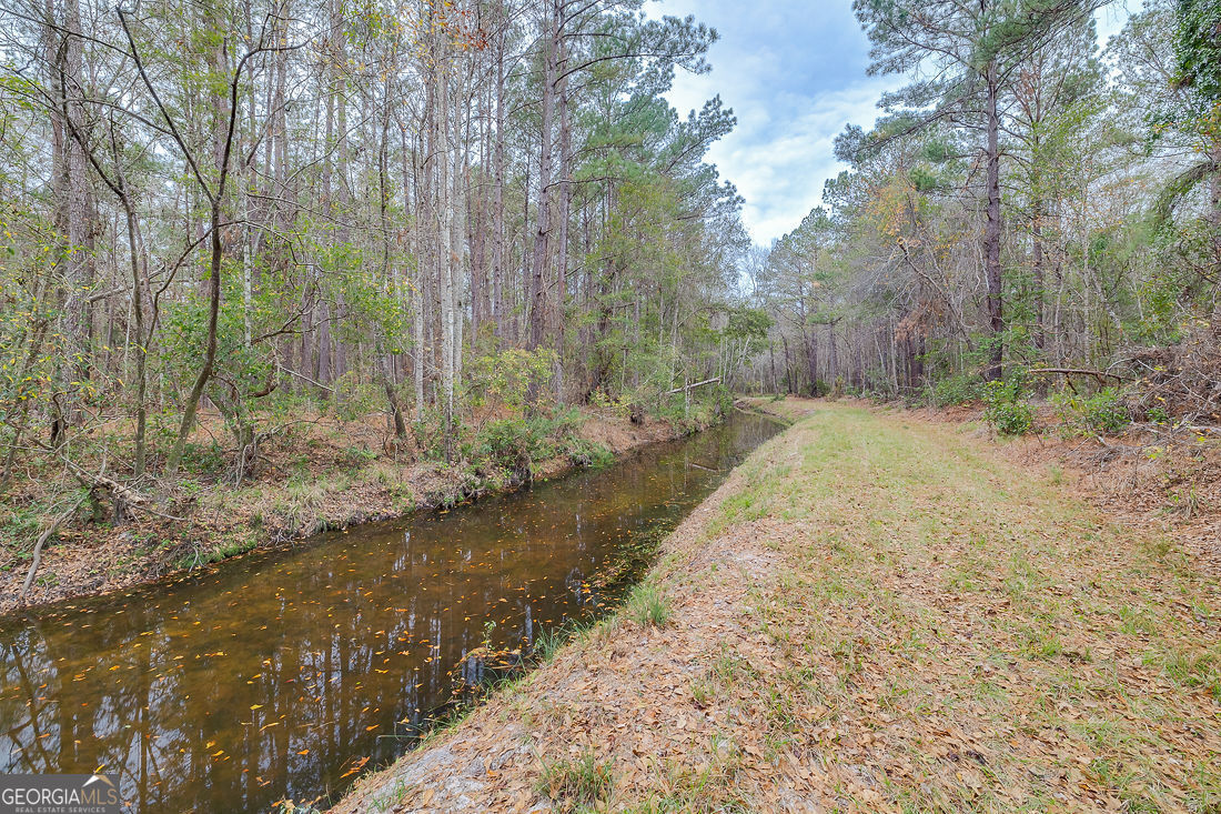 127 Winding Way Road Pembroke, GA 31321 - Photo 36 of 38 a backyard of a house with lots of green space