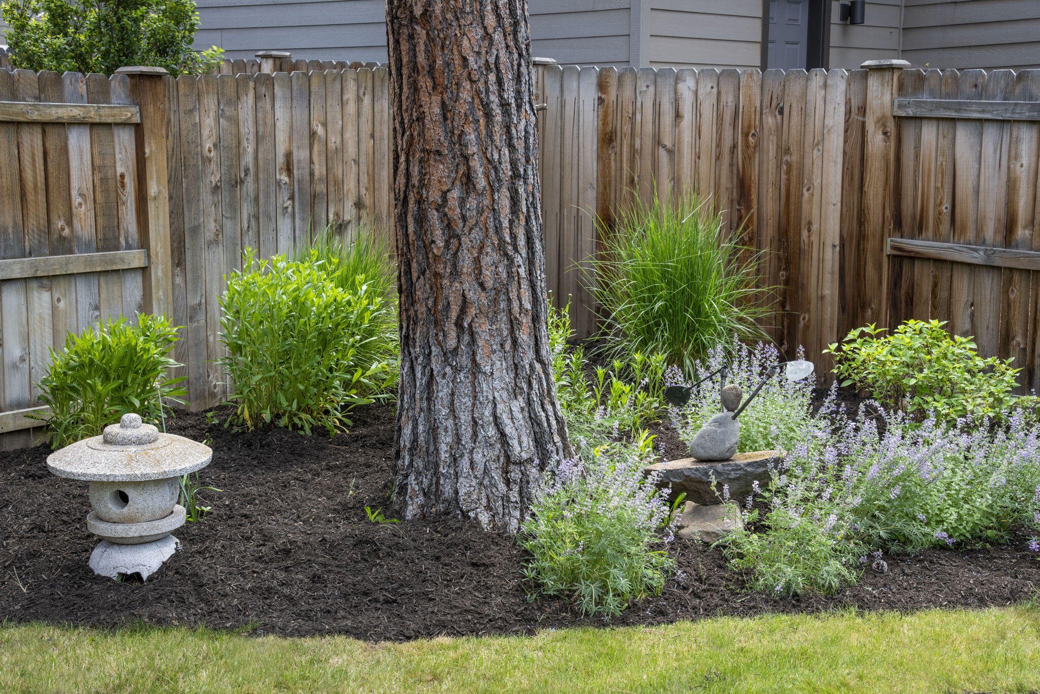 715 Brooks Camp Road Sisters, OR 97759 - Photo 25 of 25 a view of a backyard with plants and a fountain