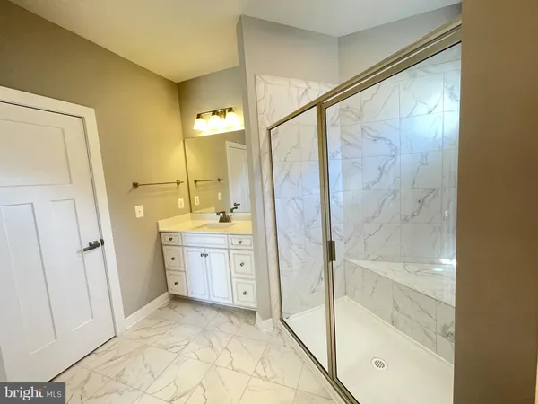 a bathroom with a shower and a sink