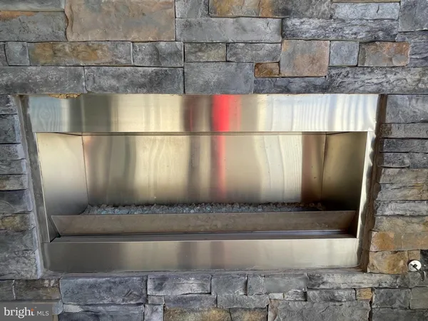 a large kitchen with stainless steel appliances kitchen island a large counter top and a wooden floors