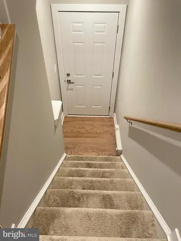 a view of a bathroom that has a sink and a shower curtain