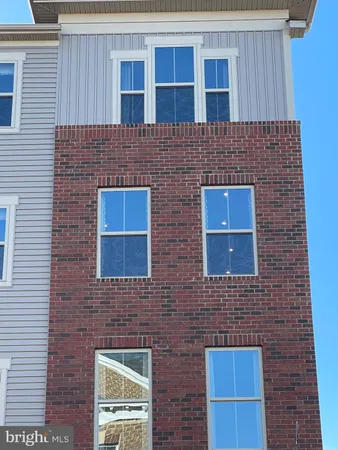 a brick building with a door and a chair
