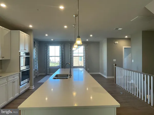 a view of a kitchen with a sink and refrigerator