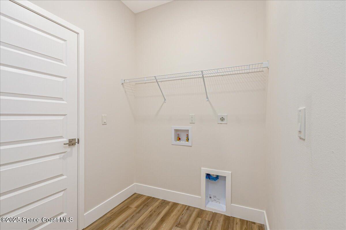 958 Chace Lane Northeast Palm Bay, FL 32905 - Photo 16 of 27 a view of walk in closet with empty racks