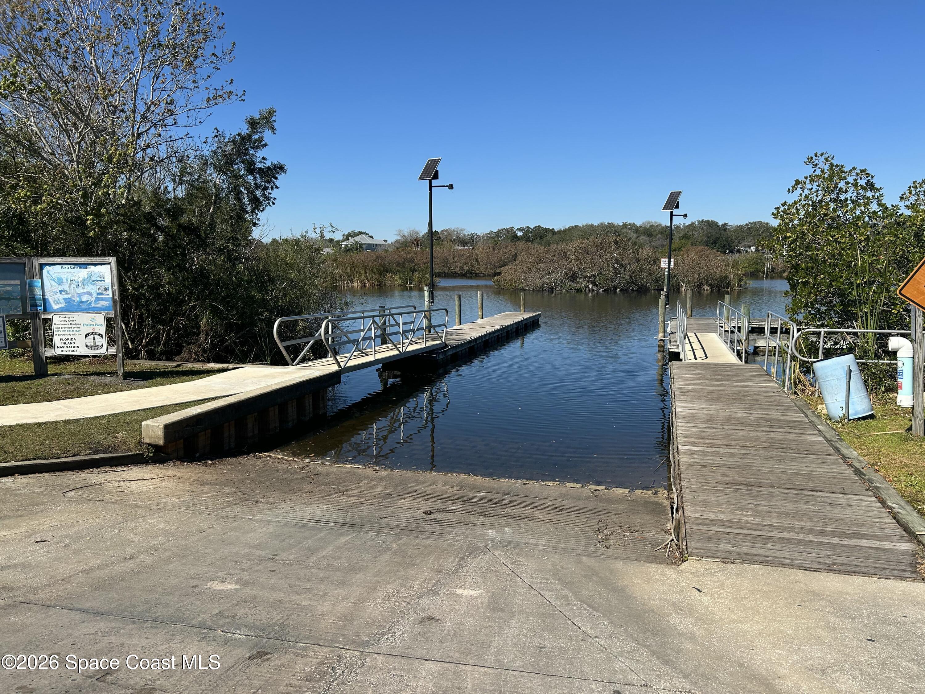 958 Chace Lane Northeast Palm Bay, FL 32905 - Photo 20 of 27 a view of a lake with a terrace