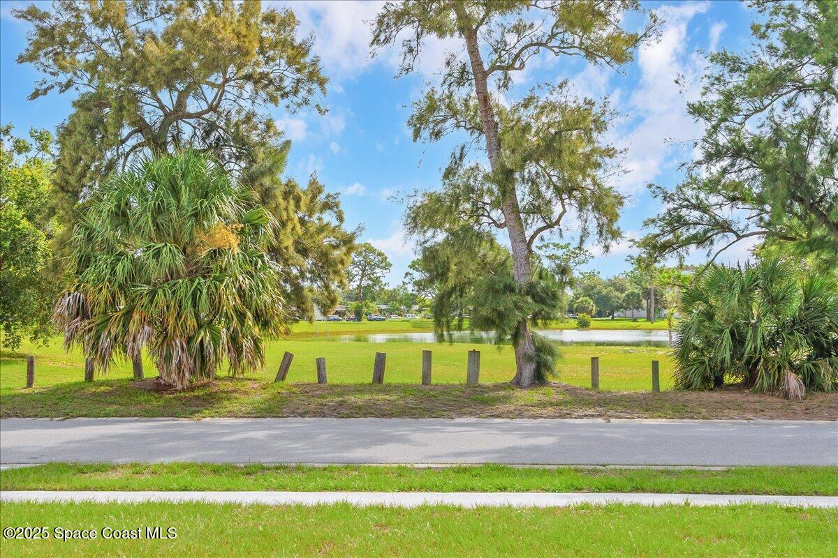 958 Chace Lane Northeast Palm Bay, FL 32905 - Photo 22 of 27 a view of swimming pool with trees in the background
