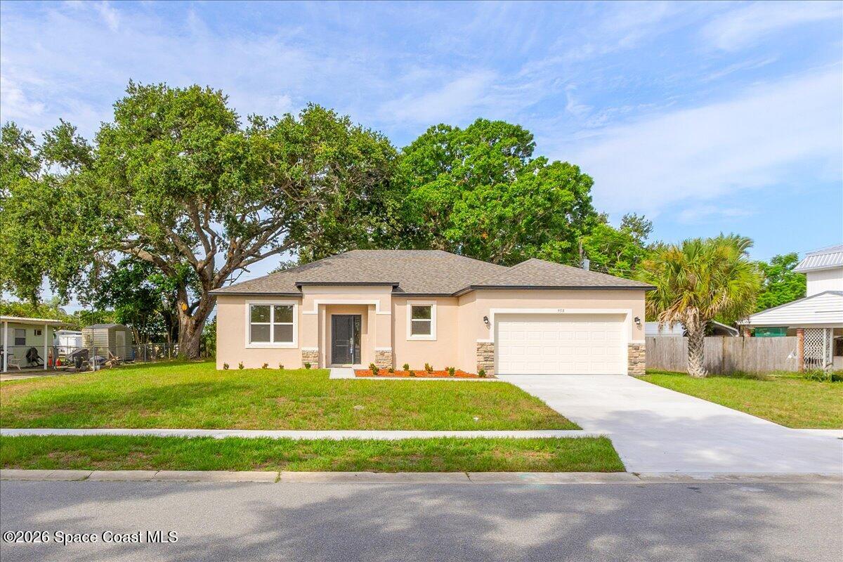 958 Chace Lane Northeast Palm Bay, FL 32905 - Photo 26 of 27 a front view of a house with a garden and yard