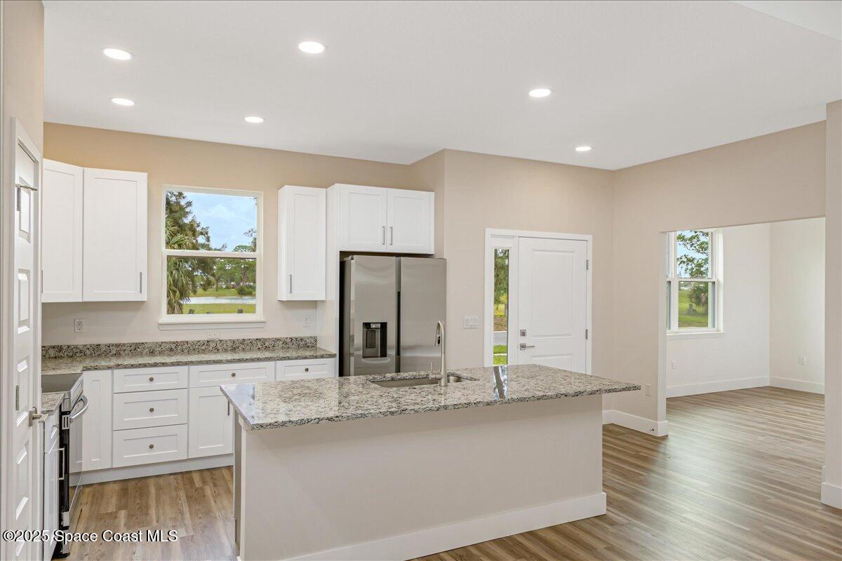 958 Chace Lane Northeast Palm Bay, FL 32905 - Photo 5 of 27 a kitchen with counter top space sink and refrigerator