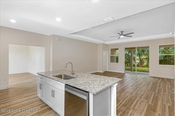 a kitchen with counter top space sink and refrigerator