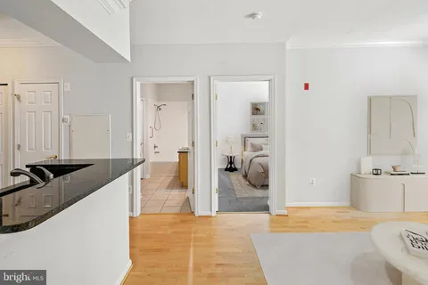 a spacious bedroom with a large bed a rug and gym equipment