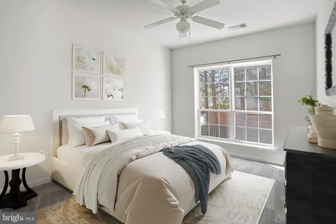 a bedroom with a large bed and a window