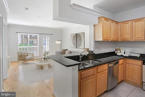 a kitchen with granite countertop a sink and cabinets
