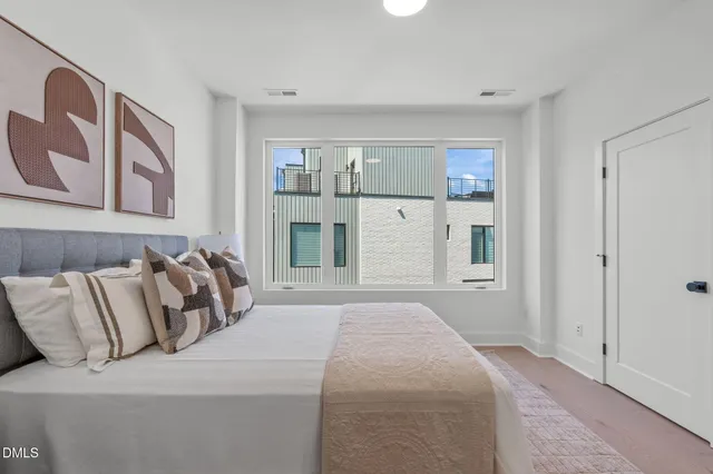 a bedroom with bed and window