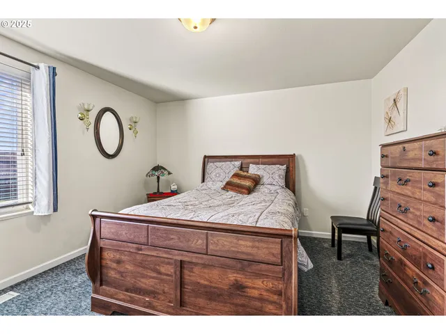 a bedroom with a bed and a dresser