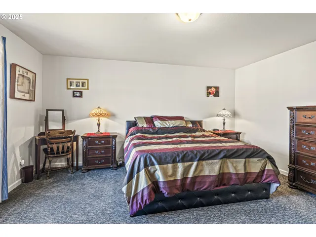 a bedroom with a bed and dresser