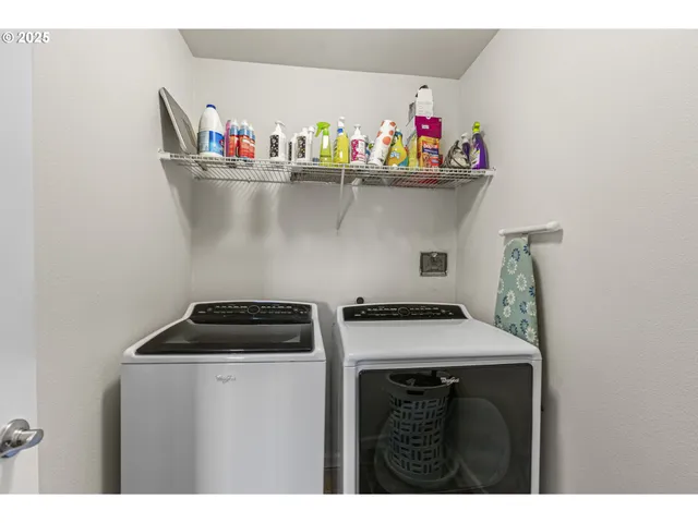a utility room with dryer washer and shoe rack