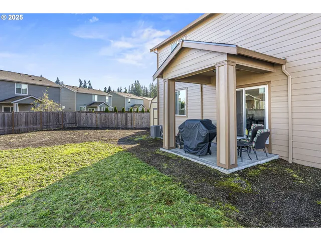 a view of a chair and table in the backyard