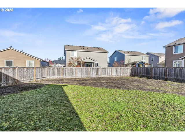 a view of house with backyard and furniture