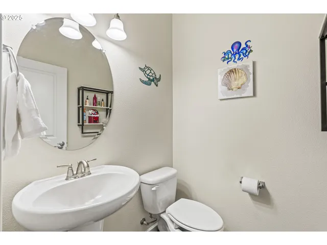 a bathroom with a toilet a sink and a mirror