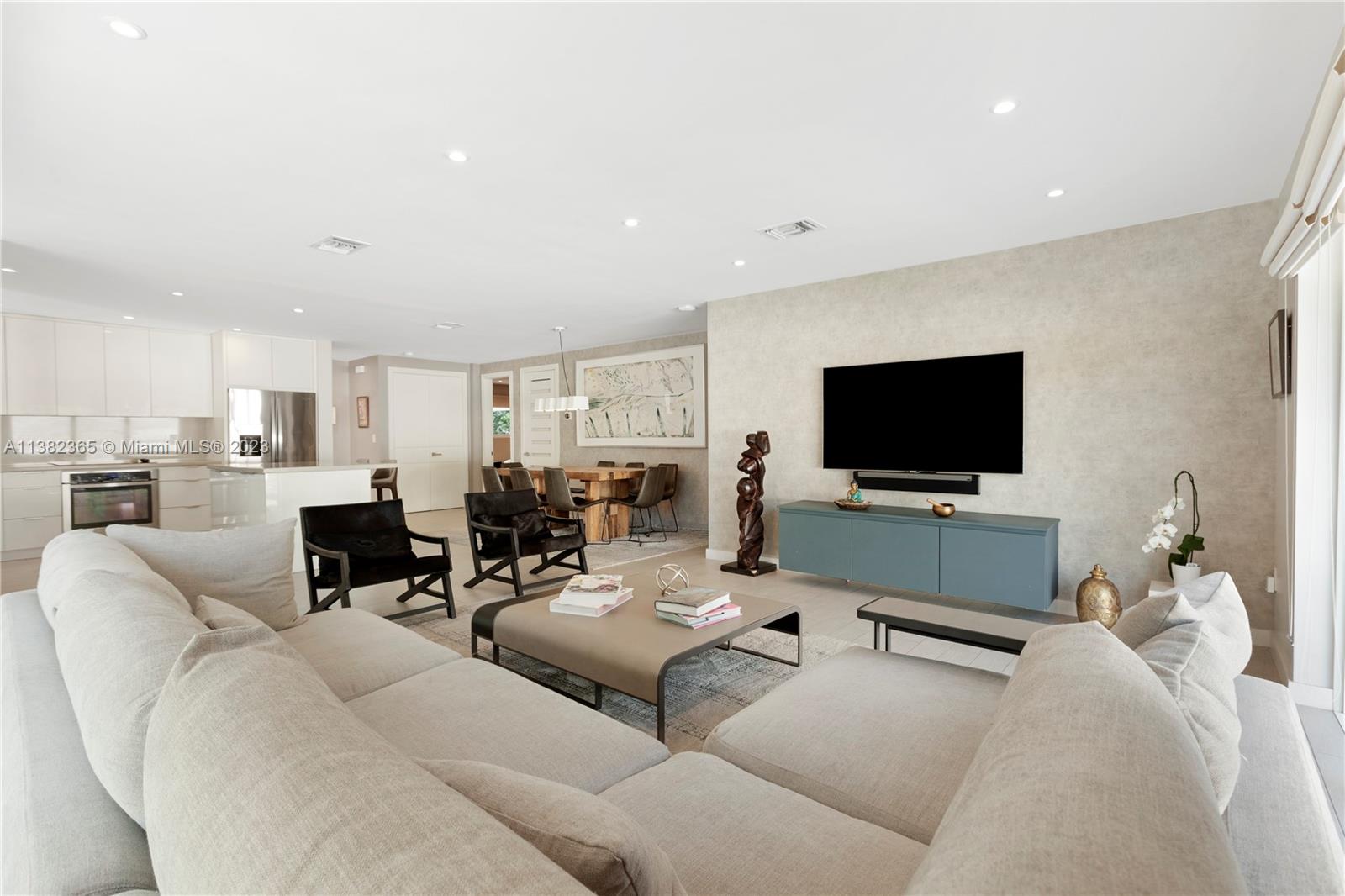 5356 Sunset Drive Miami, FL 33143 - Photo 12 of 29 a living room with furniture and a flat screen tv