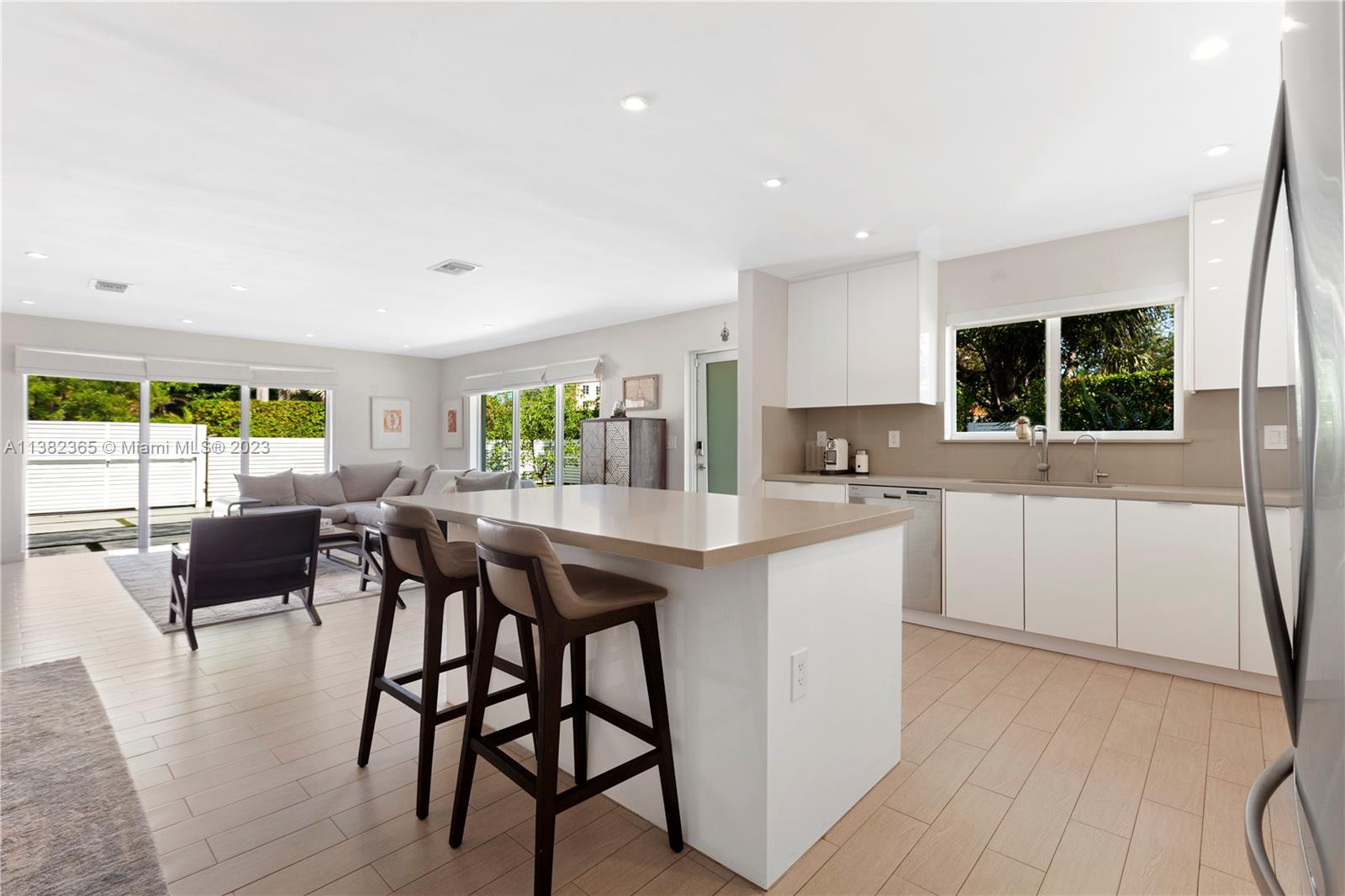 5356 Sunset Drive Miami, FL 33143 - Photo 13 of 29 a kitchen with kitchen island a dining table and chairs
