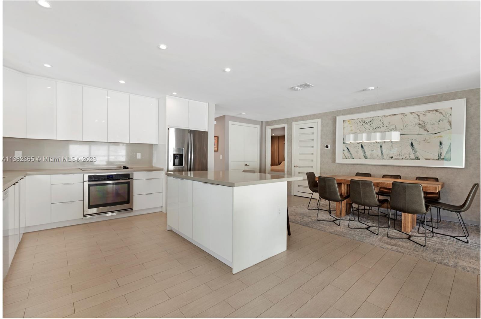 5356 Sunset Drive Miami, FL 33143 - Photo 16 of 29 a living room with stainless steel appliances furniture white walls and white cabinets
