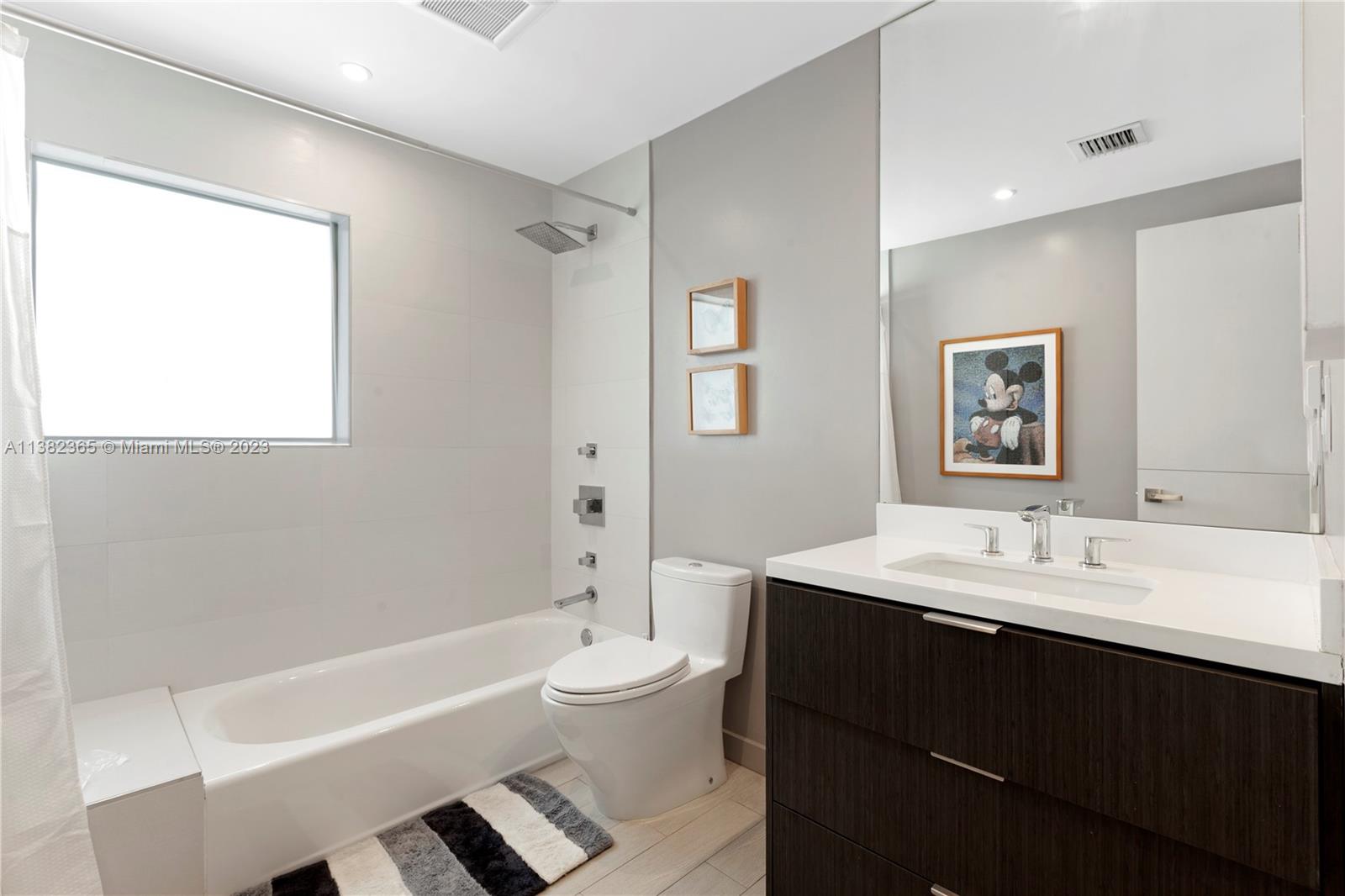 5356 Sunset Drive Miami, FL 33143 - Photo 18 of 29 a bathroom with a double vanity sink toilet and shower
