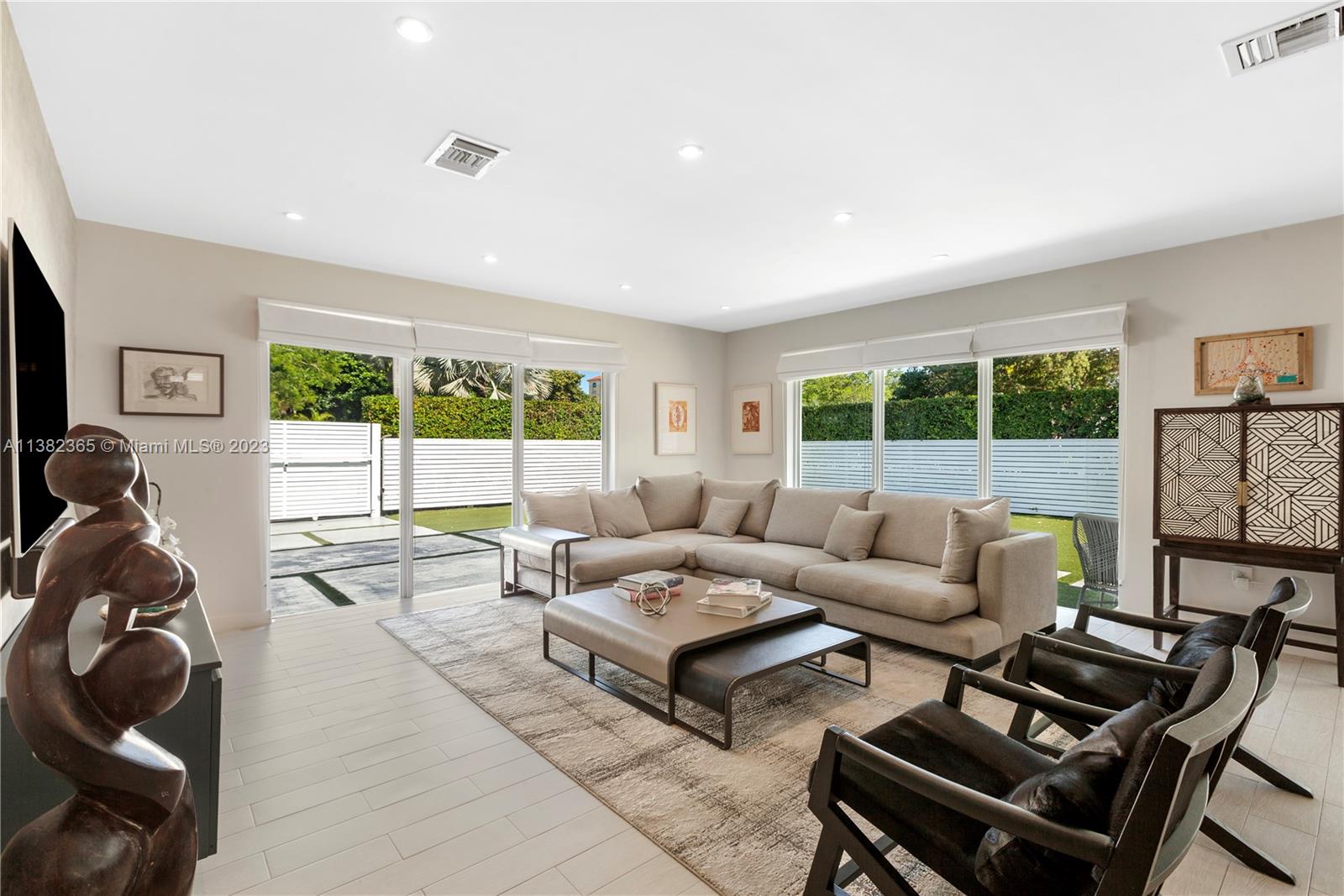 5356 Sunset Drive Miami, FL 33143 - Photo 2 of 29 a living room with furniture and a floor to ceiling window