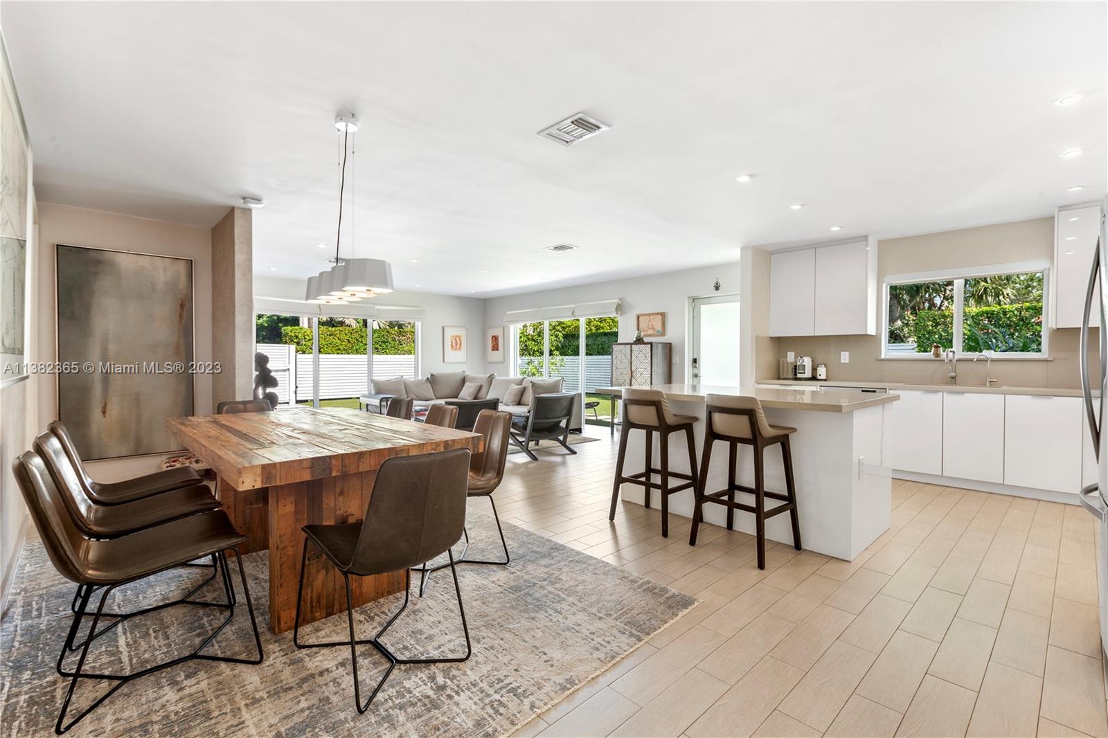 5356 Sunset Drive Miami, FL 33143 - Photo 4 of 29 a dining hall with stainless steel appliances granite countertop a table chairs and a view of living room