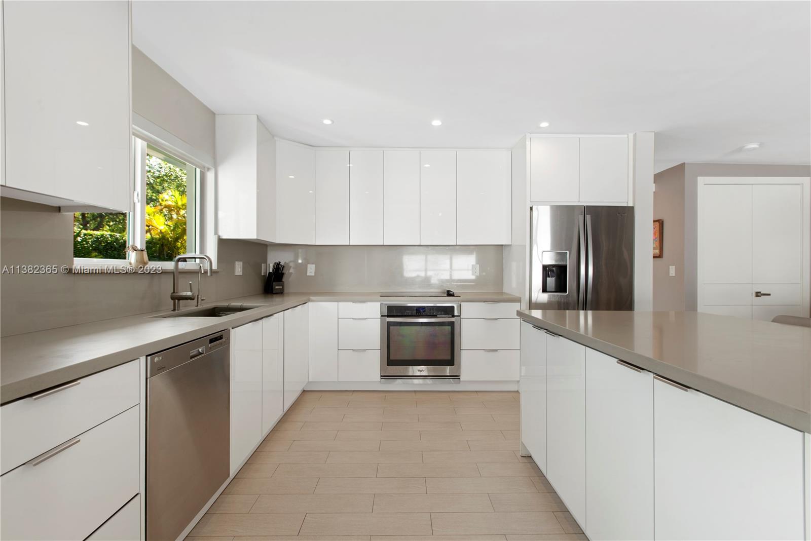 5356 Sunset Drive Miami, FL 33143 - Photo 5 of 29 a kitchen with stainless steel appliances granite countertop a refrigerator and a sink