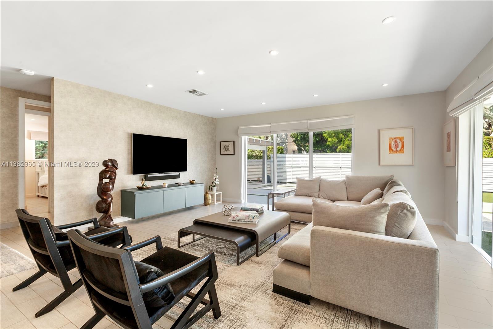 5356 Sunset Drive Miami, FL 33143 - Photo 8 of 29 a living room with furniture and a flat screen tv