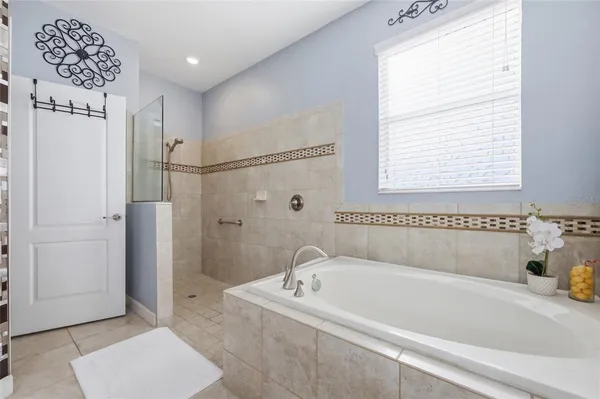 a white bath tub sitting next to a white sink