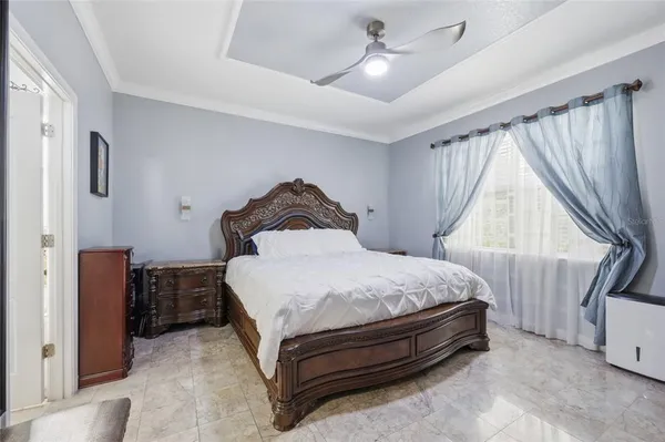 a bedroom with a bed and a large window