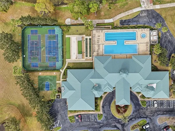 an aerial view of a house with garden space and patio