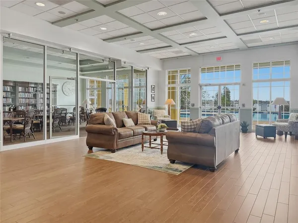 a room with furniture pool table and windows