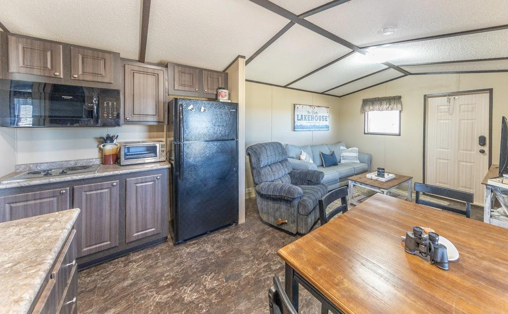 145 Lakesite Drive Spur, TX 79370 - Photo 3 of 20 a kitchen with stainless steel appliances granite countertop a refrigerator and stove
